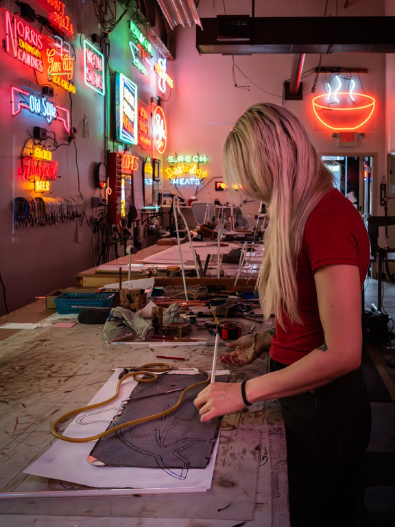Cait working in the neon shop