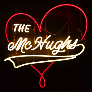 Red neon heart with "The McHughs" in white neon