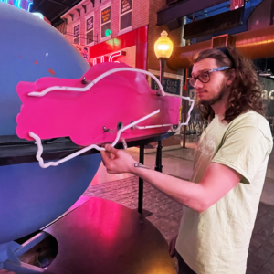 Bing holds a broken neon tube